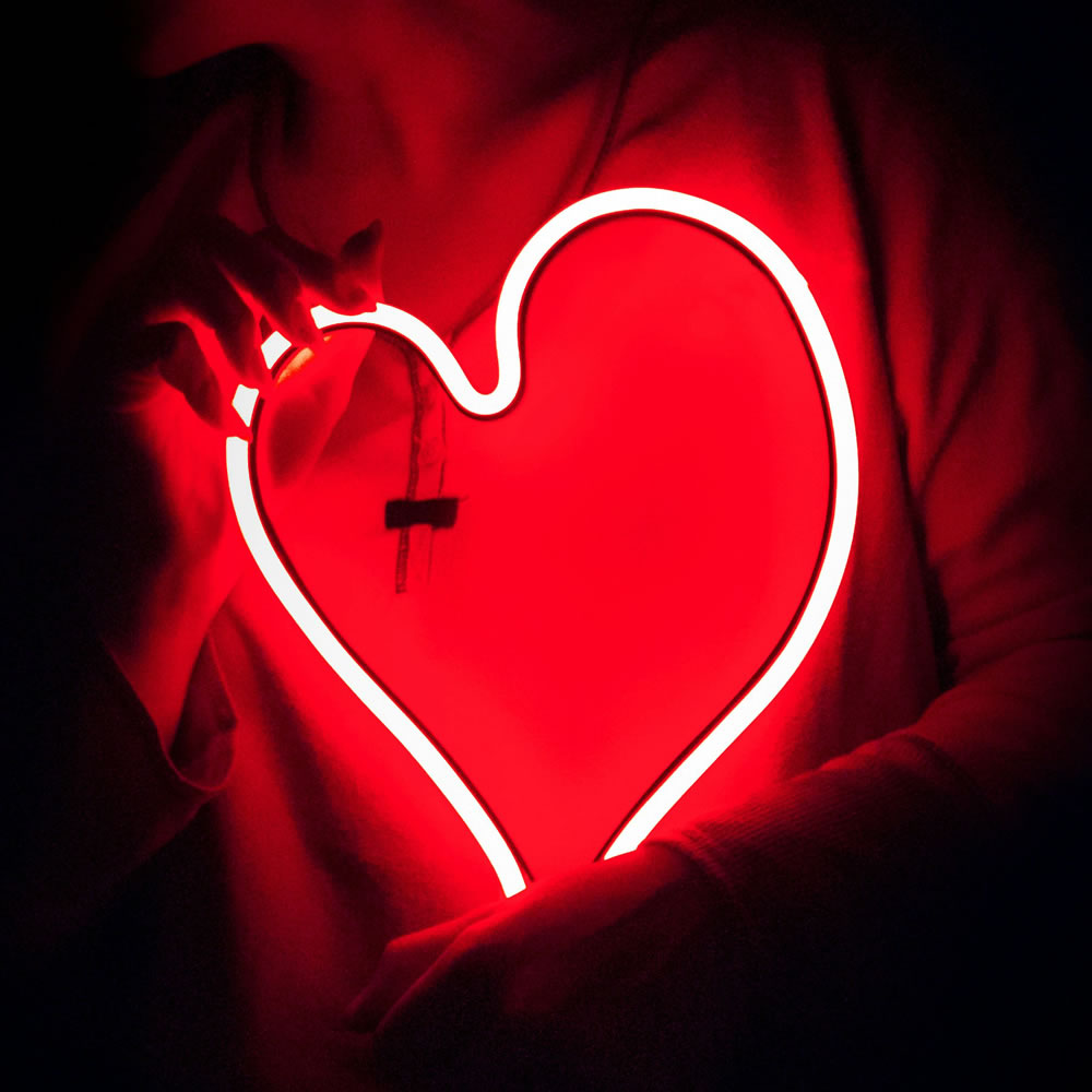 person holding heart light 